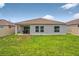 Large backyard featuring a patio area perfect for outdoor entertaining, bordered by a fence at 33960 Sky Blossom Cir, Leesburg, FL 34788