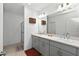 Modern bathroom featuring double sinks, a walk-in shower, and neutral paint colors at 33960 Sky Blossom Cir, Leesburg, FL 34788