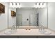 Bright bathroom featuring a double vanity, large mirror, and modern lighting fixtures at 33960 Sky Blossom Cir, Leesburg, FL 34788