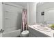 Clean bathroom with white fixtures and a modern vanity, paired with a neutral-colored shower curtain at 33960 Sky Blossom Cir, Leesburg, FL 34788