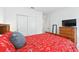 Comfortable bedroom featuring warm colored bedding, closet, and furniture with carpet flooring at 33960 Sky Blossom Cir, Leesburg, FL 34788