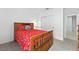 Cozy bedroom showcasing warm colored bedding, closet, and furniture with carpet flooring at 33960 Sky Blossom Cir, Leesburg, FL 34788