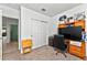 Bedroom featuring a large desk, built in shelving, neutral carpet and light-colored walls at 33960 Sky Blossom Cir, Leesburg, FL 34788