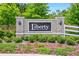 Elegant brick community sign with 'Liberty Preserve' lettering, surrounded by lush greenery and landscaping at 33960 Sky Blossom Cir, Leesburg, FL 34788