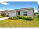 Inviting single-Gathering home featuring a spacious two-car garage and lush front yard at 33960 Sky Blossom Cir, Leesburg, FL 34788