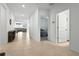 Bright hallway featuring tile flooring that flows into an open living space with furniture at 33960 Sky Blossom Cir, Leesburg, FL 34788