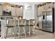 Kitchen features stainless appliances, breakfast bar, and stylish gray cabinetry at 33960 Sky Blossom Cir, Leesburg, FL 34788