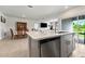 This modern kitchen island features stainless steel appliances and overlooks the dining area at 33960 Sky Blossom Cir, Leesburg, FL 34788