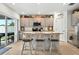 Well-lit kitchen features a breakfast bar with seating and sliding glass door at 33960 Sky Blossom Cir, Leesburg, FL 34788