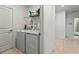 Functional laundry room with washer, dryer, storage shelf, and convenient access to other areas of the home at 33960 Sky Blossom Cir, Leesburg, FL 34788