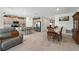 Open floor plan with kitchen island, stainless appliances, dining area, and living room at 33960 Sky Blossom Cir, Leesburg, FL 34788