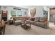 The living room features tile flooring, neutral colors and natural light from the large windows at 33960 Sky Blossom Cir, Leesburg, FL 34788