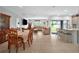 Open-concept layout with a dining area seamlessly flowing into a well-lit living room and modern kitchen at 33960 Sky Blossom Cir, Leesburg, FL 34788