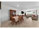 Open-concept dining and living area featuring a dining table, comfortable seating, and abundant natural light at 33960 Sky Blossom Cir, Leesburg, FL 34788
