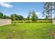 Beautiful view of the property's spacious, green yard, lined with a charming white fence at 33960 Sky Blossom Cir, Leesburg, FL 34788