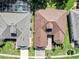 Bird's eye view showcases the neatly landscaped lawns, paved driveways, and well-maintained roofs of two homes at 3519 Arlington Ridge Blvd, Leesburg, FL 34748
