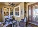Inviting front porch seating area, featuring stylish furniture, decor, and an elegant front door at 3519 Arlington Ridge Blvd, Leesburg, FL 34748