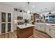 Well-lit kitchen with marble countertops, stainless steel appliances, and wood flooring at 3519 Arlington Ridge Blvd, Leesburg, FL 34748