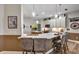 Kitchen with marble countertops, stainless steel appliances, island with barstool seating and hanging lights at 3519 Arlington Ridge Blvd, Leesburg, FL 34748