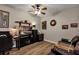 Cozy living room with a desk, entertainment center, and leather sofa, providing a comfortable space to unwind and relax at 3519 Arlington Ridge Blvd, Leesburg, FL 34748