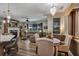 Open-concept living room featuring hardwood floors, modern furniture, fireplace, and lots of natural light at 3519 Arlington Ridge Blvd, Leesburg, FL 34748