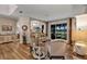 Open-concept living room showcasing hardwood floors, neutral furniture, and sliding doors to the screened patio at 3519 Arlington Ridge Blvd, Leesburg, FL 34748