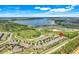 Panoramic aerial view of the community with a lake, residences, and a scenic backdrop at 3550 Fairwaters Ct # D, Clermont, FL 34711