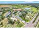 Stunning aerial view of community amenities, including pool, tennis courts, and lake at 3550 Fairwaters Ct # D, Clermont, FL 34711