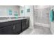 Elegant bathroom with double vanity, granite countertop, and a glass-enclosed shower at 3550 Fairwaters Ct # D, Clermont, FL 34711