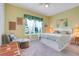 Cozy bedroom with a bright window, comfortable chair and footrest, and a queen sized bed at 3550 Fairwaters Ct # D, Clermont, FL 34711