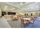 Expansive event space featuring tables, chairs, and a stage, perfect for gatherings and performances at 3550 Fairwaters Ct # D, Clermont, FL 34711