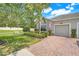 Charming home with brick driveway, well-kept lawn, and an American flag at 3550 Fairwaters Ct # D, Clermont, FL 34711