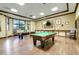 The game room features two pool tables, pendant lighting, and comfortable leather chairs at 3550 Fairwaters Ct # D, Clermont, FL 34711