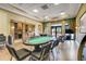 Spacious game room with a poker table, kitchen area, and large windows with views at 3550 Fairwaters Ct # D, Clermont, FL 34711