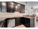 Modern kitchen features granite countertops, stainless steel appliances, and dark wood cabinets at 3550 Fairwaters Ct # D, Clermont, FL 34711