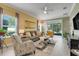 Bright living room with neutral color palette, comfortable seating, and sliding glass doors to outdoor area at 3550 Fairwaters Ct # D, Clermont, FL 34711