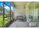 Relaxing screened-in patio with comfortable bench seating and a view of the backyard at 3550 Fairwaters Ct # D, Clermont, FL 34711