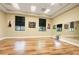 Bright yoga studio with wood floors, large windows, mirrors, and art pieces at 3550 Fairwaters Ct # D, Clermont, FL 34711