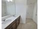 Bathroom features double sinks, quartz countertop and wood cabinetry at 358 Switchgrass Loop, Minneola, FL 34715