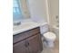 Neutral bathroom with a dark vanity, white countertop, bathtub and a large mirror at 358 Switchgrass Loop, Minneola, FL 34715