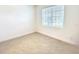 Bedroom features ceramic tile flooring, trim and a window for natural lighting at 358 Switchgrass Loop, Minneola, FL 34715