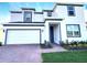 Charming two-story home with a two car garage, landscaped yard, and neutral color palette at 358 Switchgrass Loop, Minneola, FL 34715