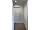 Hallway area with carpet, white door, and bright white walls at 358 Switchgrass Loop, Minneola, FL 34715