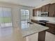 Kitchen with dark cabinets, stainless steel appliances, and a granite island at 358 Switchgrass Loop, Minneola, FL 34715
