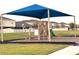 Community playground area with shade covering, climbing structures, slide, and open green space at 358 Switchgrass Loop, Minneola, FL 34715
