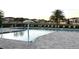 Community pool features a splash umbrella, lounge seating, clear water, and verdant landscaping at 358 Switchgrass Loop, Minneola, FL 34715
