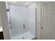 Bathroom featuring a glass-enclosed standing shower with tile surround at 358 Switchgrass Loop, Minneola, FL 34715