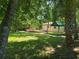Large backyard with a partially covered picnic area, house with a small deck and a partially visible palm tree at 365 Fletcher Ave, Daytona Beach, FL 32114