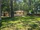 Wide backyard with a house featuring a small deck, and a partially covered picnic area at 365 Fletcher Ave, Daytona Beach, FL 32114