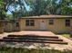 Backyard with wooden deck and brick patio at 365 Fletcher Ave, Daytona Beach, FL 32114